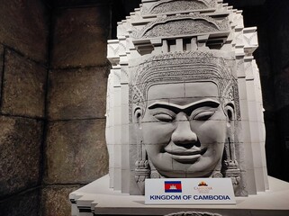 Dubai, UAE- April 21 2022: Large head sculpture of the Khmer Buddha created from grey rock. Angkor...
