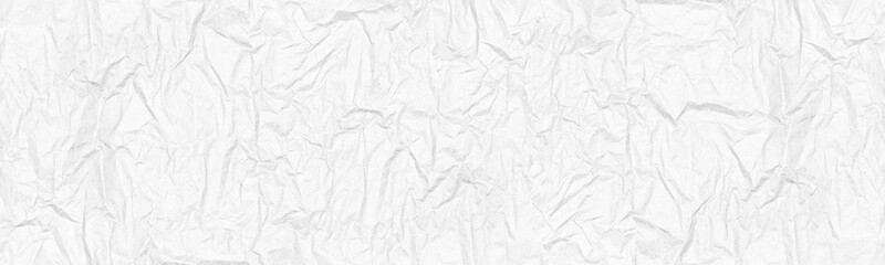 White crumpled kraft paper wide panoramic texture. Blank wrinkled paper sheet top view. Abstract light grey vintage banner background