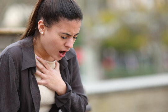 Stressed woman having problems to breath in a park