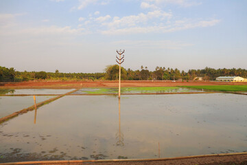 Water reflection of a current pole and pole mark with farming overview
