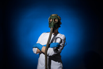 doctor woman in a gas mask and gloves with a stethoscope in her hands on a blue background