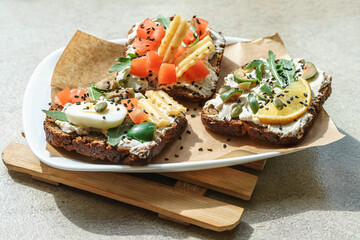 Set of open rye bread sandwiches with various fillings. Variety of open sandwiches. Assorted small sandwiches.
