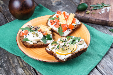 Set of open rye bread sandwiches with various fillings. Variety of open sandwiches. Assorted small sandwiches.