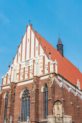 Fototapeta na wymiar Basilica of st. James the Apostle and St. Agnieszka in Nysa. .Gothic cathedral.The temple was built of stone and brick, covered with a steep ceramic roof. The steepest roof in Europe