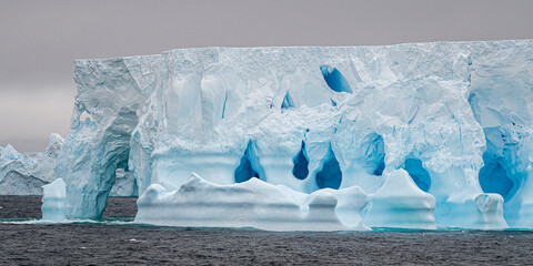 Antarctic Tabular Iceberg closeup from blue rifts and caves 