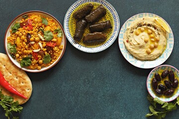 Vegan Moroccan Couscous with Chick Peas, spinach, dried apricots and date fruit. Traditional African Tajine dish. Flat layot