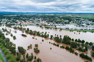 Flooding river with floodwaters reaching up the levee bank