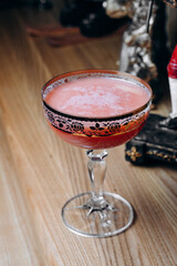 beautiful delicious orange cocktail in an elegant glass on a silver tray different beautiful cocktails in warm colors on a dark background. cocktail or bar menu concept.