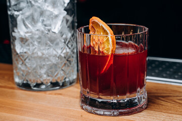 Homemade cocktail on Red Boulevard. glass martini with raspberry cocktail with raspberry alcohol and orange garnish.Cafe advertisement. Bar menu