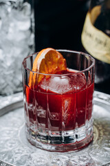 Homemade cocktail on Red Boulevard. glass martini with raspberry cocktail with raspberry alcohol and orange garnish.Cafe advertisement. Bar menu