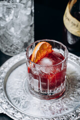 Homemade cocktail on Red Boulevard. glass martini with raspberry cocktail with raspberry alcohol and orange garnish.Cafe advertisement. Bar menu