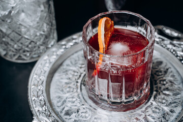 Homemade cocktail on Red Boulevard. glass martini with raspberry cocktail with raspberry alcohol and orange garnish.Cafe advertisement. Bar menu
