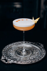 Pisco sour cocktail. Whiskey Sour in Coupe Glass with ice on gray background. Overhead view, copy space. Advertising for cafe. Bar menu.