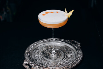 Pisco sour cocktail. Whiskey Sour in Coupe Glass with ice on gray background. Overhead view, copy space. Advertising for cafe. Bar menu.