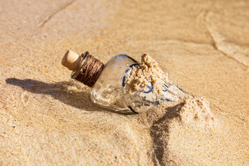 Alte Flasche im Sand am Strand im Wasser, am Ozean.
