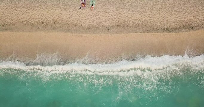 Aerial view of the amazing idyllic beach with waved sea.