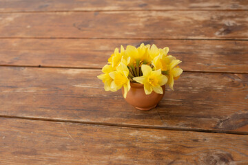 yellow  flowers in wooden table