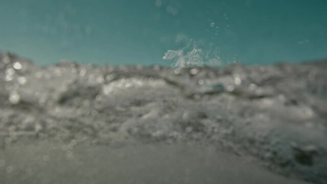 Vitality of blue energy and clear ocean water. Powerful stormy sea waves in top-down drone shot perspective. Crashing wave line in Open Atlantic sea with foamy white texture.