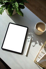Blank tablet mockup on table. Aesthetic home office desk with tablet, pen, cup of coffee, office...