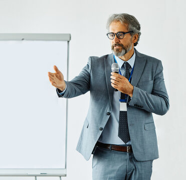 business meeting conference presentation businessman man office seminar corporate group training education communication manager  educator lecturer classroom mature active senior microphone