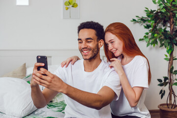 Young couple in love taking a selfie together at home.