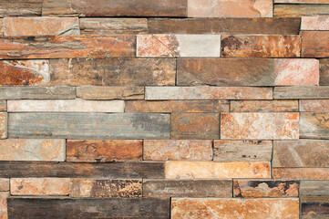 Brown stone wall tiles texture.Grunge wall pattern design or abstract background.