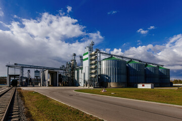 Fototapeta na wymiar Modern agricultural grain drying complex and silos