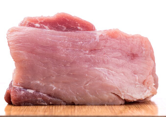Close-up slice of fresh pork meat on a cutting board.