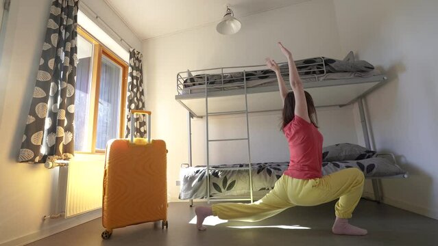 Refugee camp. A woman is doing exercises in the room.