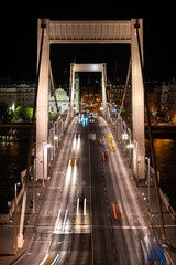 Night view of cars and buses driving on Elizabeth bridge in Budapest