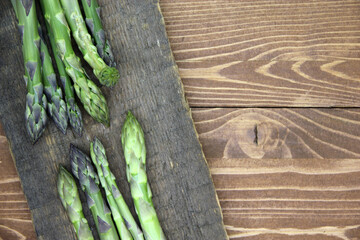 Fresh green asparagus on a wooden background