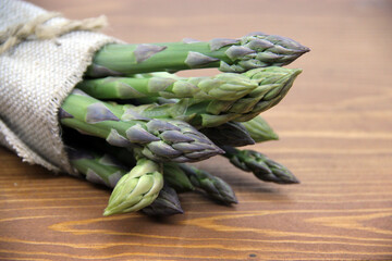 Fresh green asparagus on a wooden background