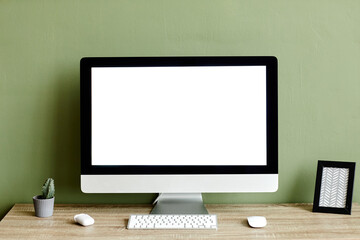 Minimal background image of white computer screen at home workplace against green, mock up
