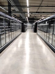 Naklejka premium New shop equipment, refrigerators and freezers and shelves in a new supermarket