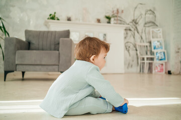 baby boy sitting on the floor in the sun's rays