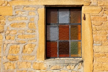 Typical wall of golden stones in the village of Theize in Beaujolais, France