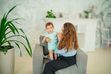 mother with baby on a gray chair