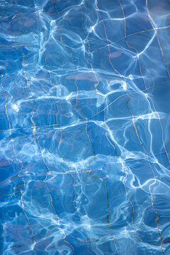 Abstract background. Sun glare from water distortion. Swimming pool.