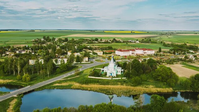 Krupets, Dobrush District, Gomel Region, Belarus. Aerial View Of Old Wooden Orthodox Church Of The Holy Trinity At Sunny Summer Evening. Drone Hyper lapse. 4K.