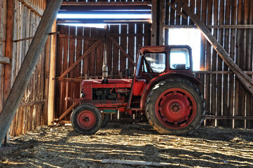 Red tractor in barn