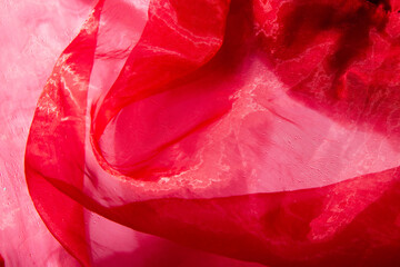 Beautiful red tulle with shiny beads background. Draped background of pink powdery fabric, texture....