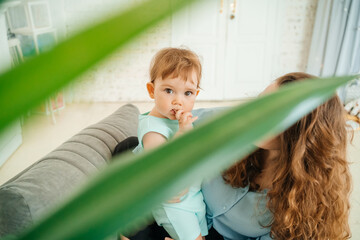 mother with baby on a gray chair