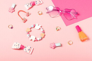 Baby accessories sunglasses and a hat on a pink background. Little girls accessories, flat lay