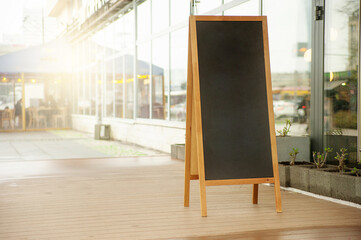 Chalkboard menu sign mockup. Blank advertising board on city street. Banners with room to add your own text