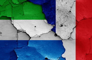 flags of Sierra Leone and France painted on cracked wall