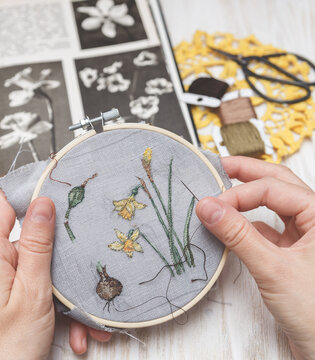 Woman making handmade embroidery. Process of making embroidery. Hobby. Sewing tools.
