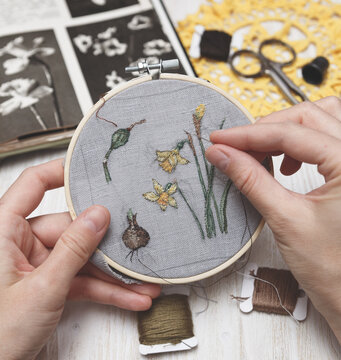 Woman making handmade embroidery. Process of making embroidery. Hobby. Sewing tools.