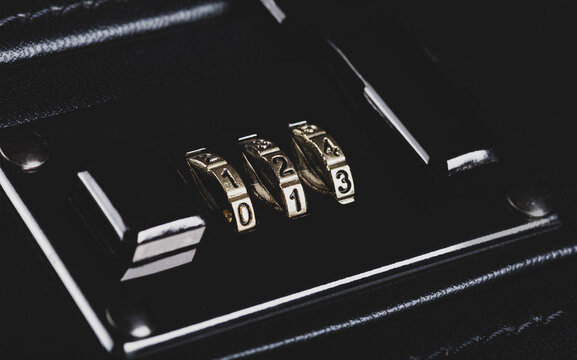 Simple code lock on a dark black premium suitcase. Belongings protection, data safety, security abstract concept, number combination lock object macro, detail, extreme closeup, matte shot, nobody
