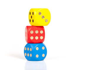 Three simple colorful game dice stacked on top of each other, unstable built structure, business strategy plan, numbers, luck, education concept, copy space, group of objects isolated on white, nobody