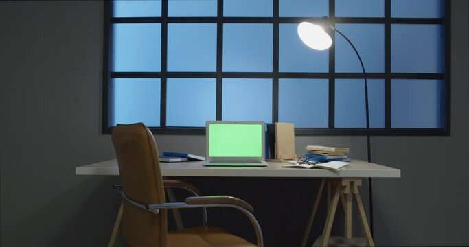 Laptop with blank screen at workplace in home library